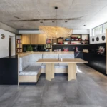 This bespoke kitchen showcases the perfect balance of warmth and modernity, combining natural timber finishes, sleek black cabinetry, integrated storage, and custom banquette seating. Every element is thoughtfully designed to enhance both functionality and everyday living.